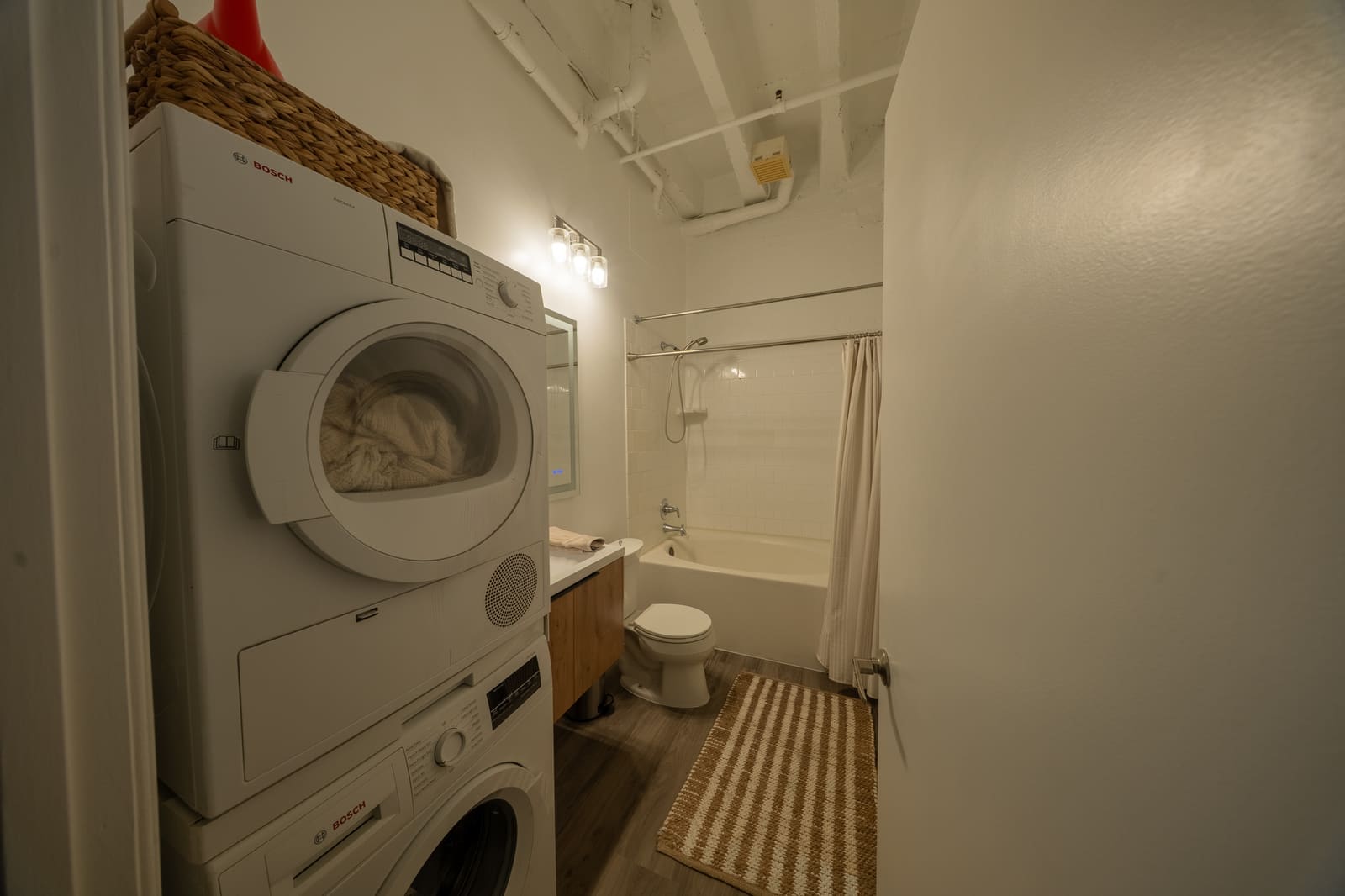 Bathroom with in-unit Bosch washer and dryer