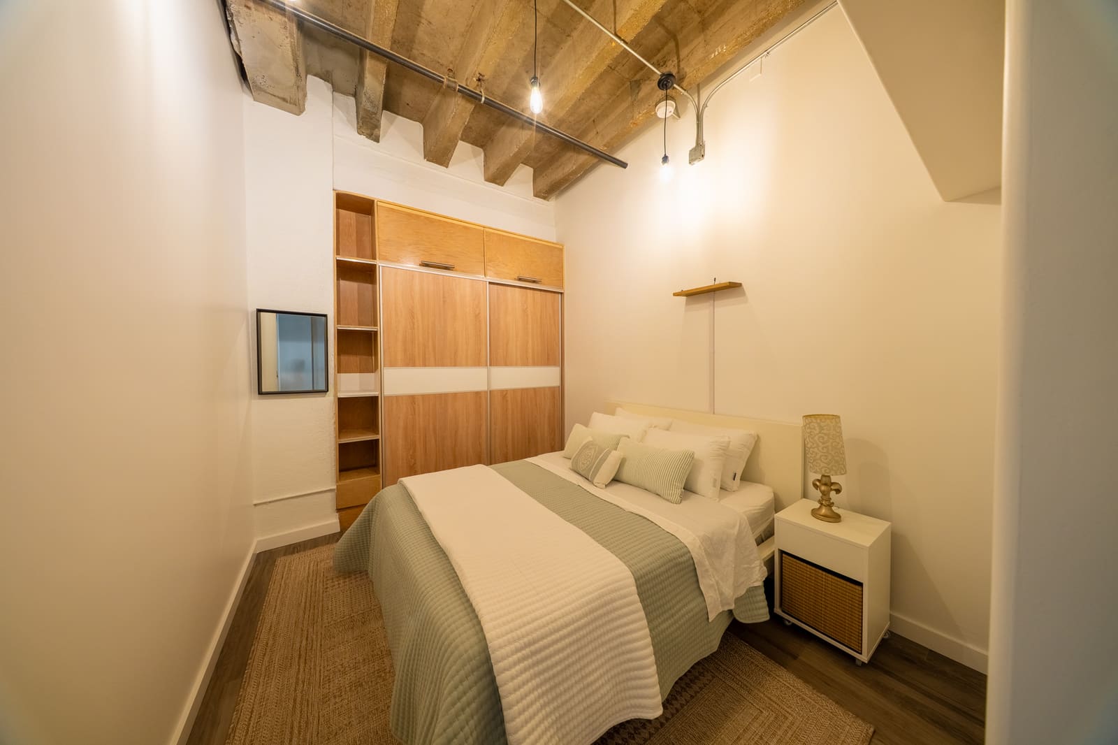 Bedroom with bed, wardrobe storage, and nightstand