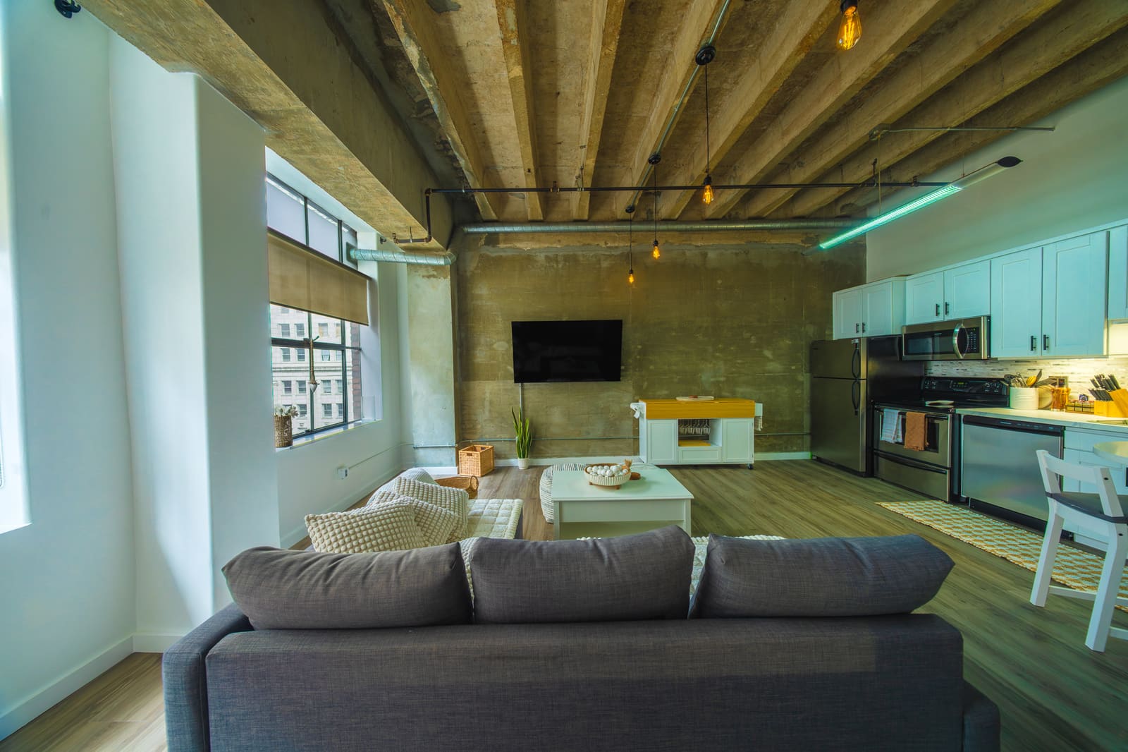 Loft living area with tall windows and comfortable seating